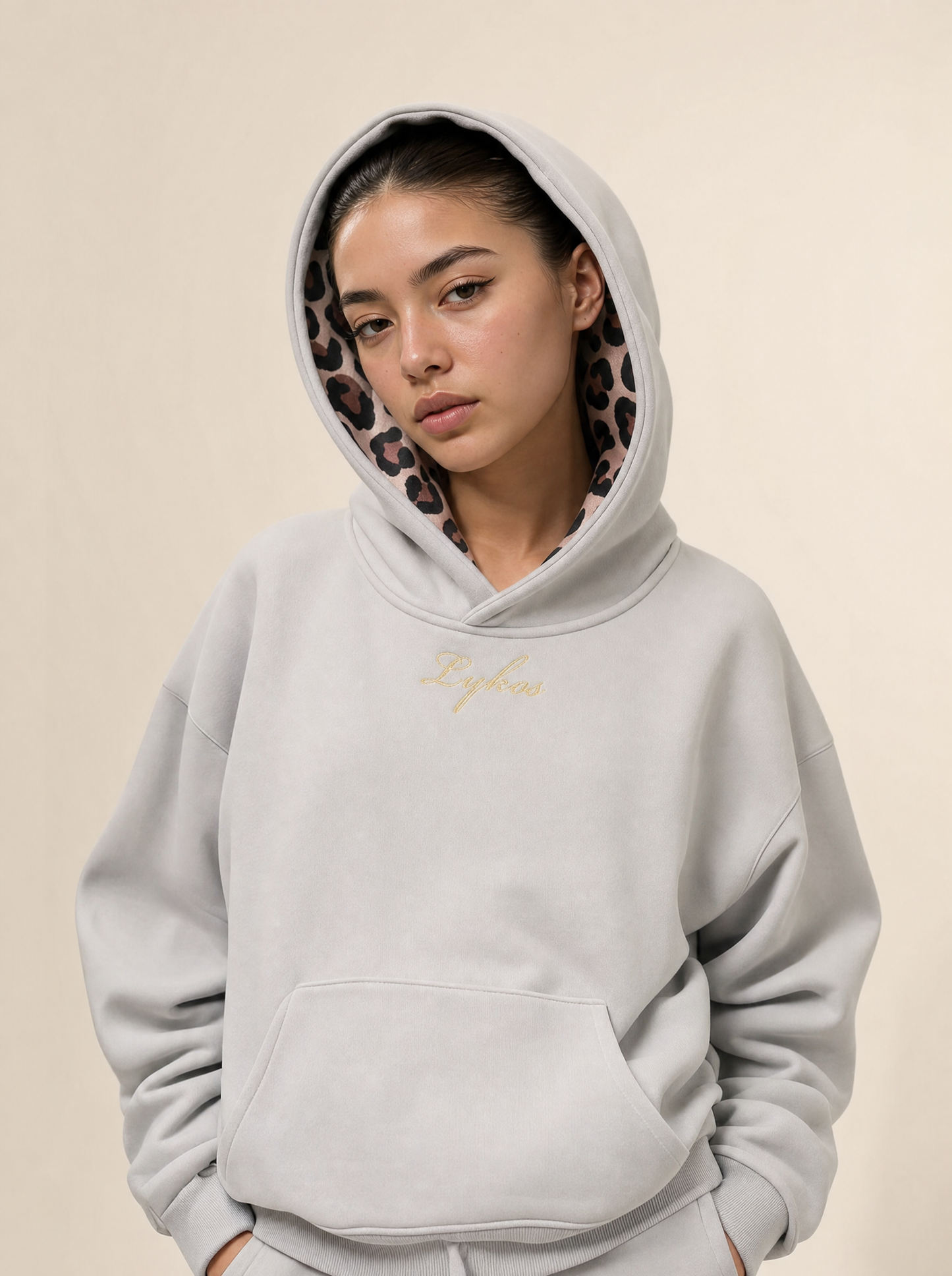 Origin Hoodie Grey worn with the hood up, leopard lining framing the face