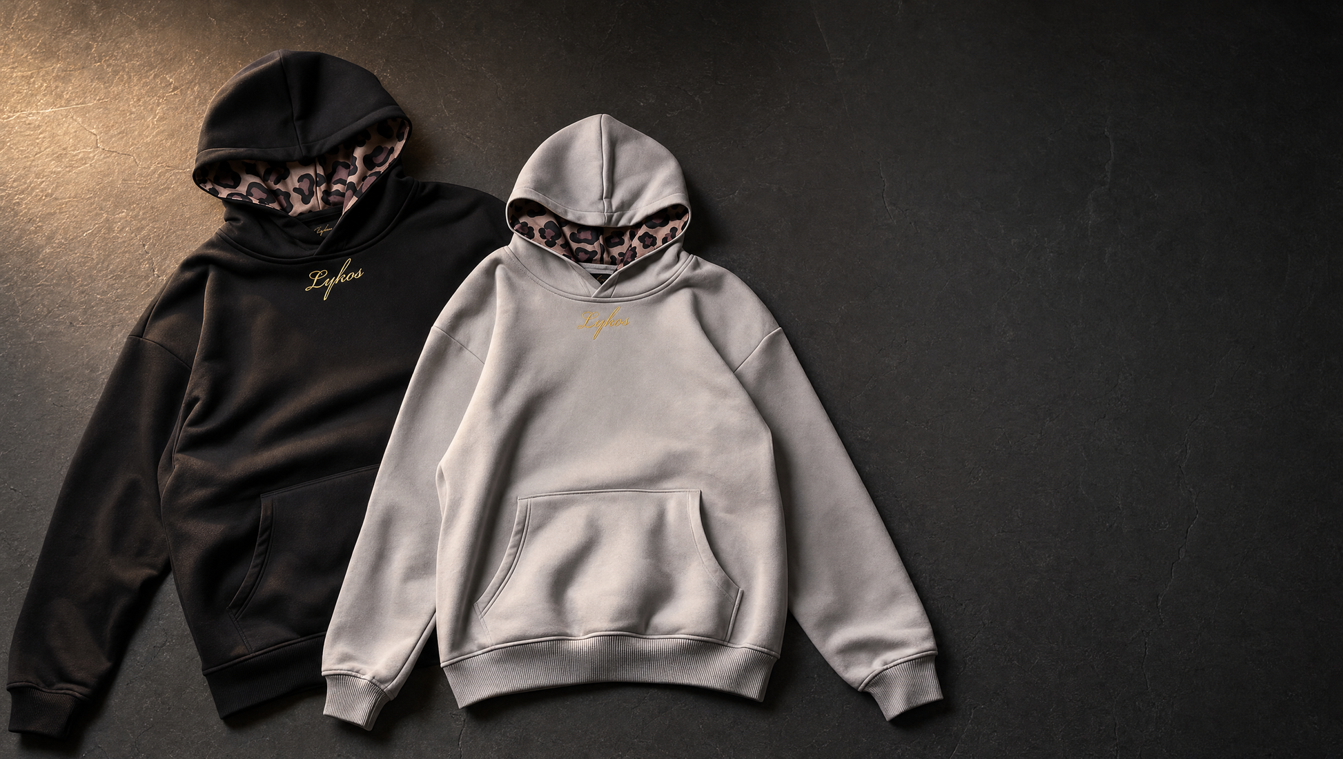 Origin Hoodie in black and grey laid side by side with leopard linings showing