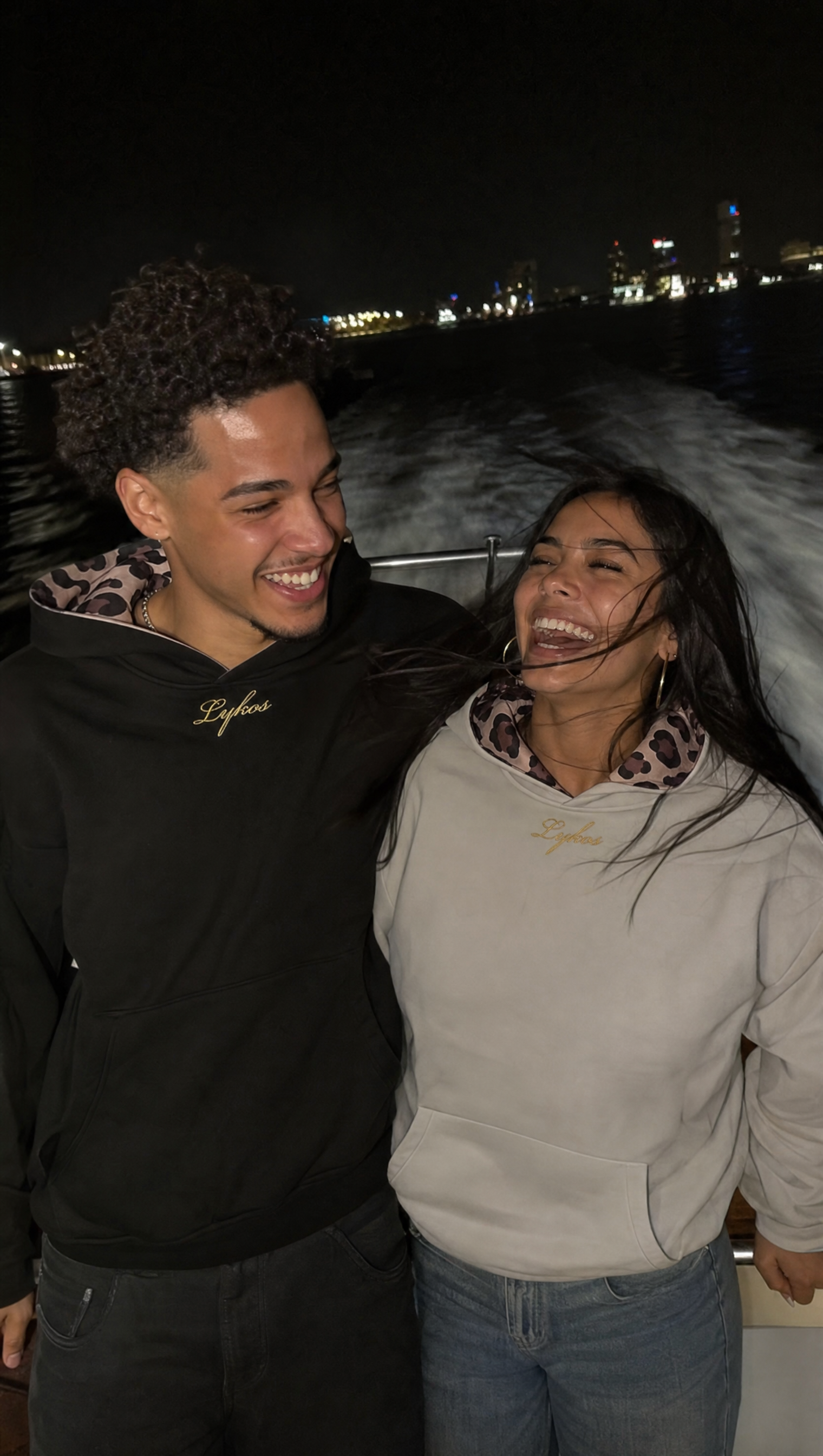 Origin Hoodie Grey and Black worn on a boat at night